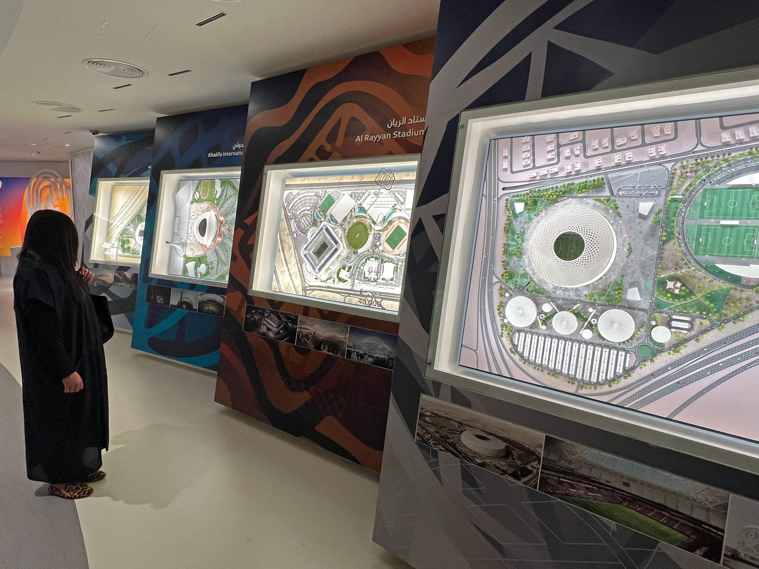 A delegate viewing the various stadium designs for the 2022 FIFA World Cup in Qatar